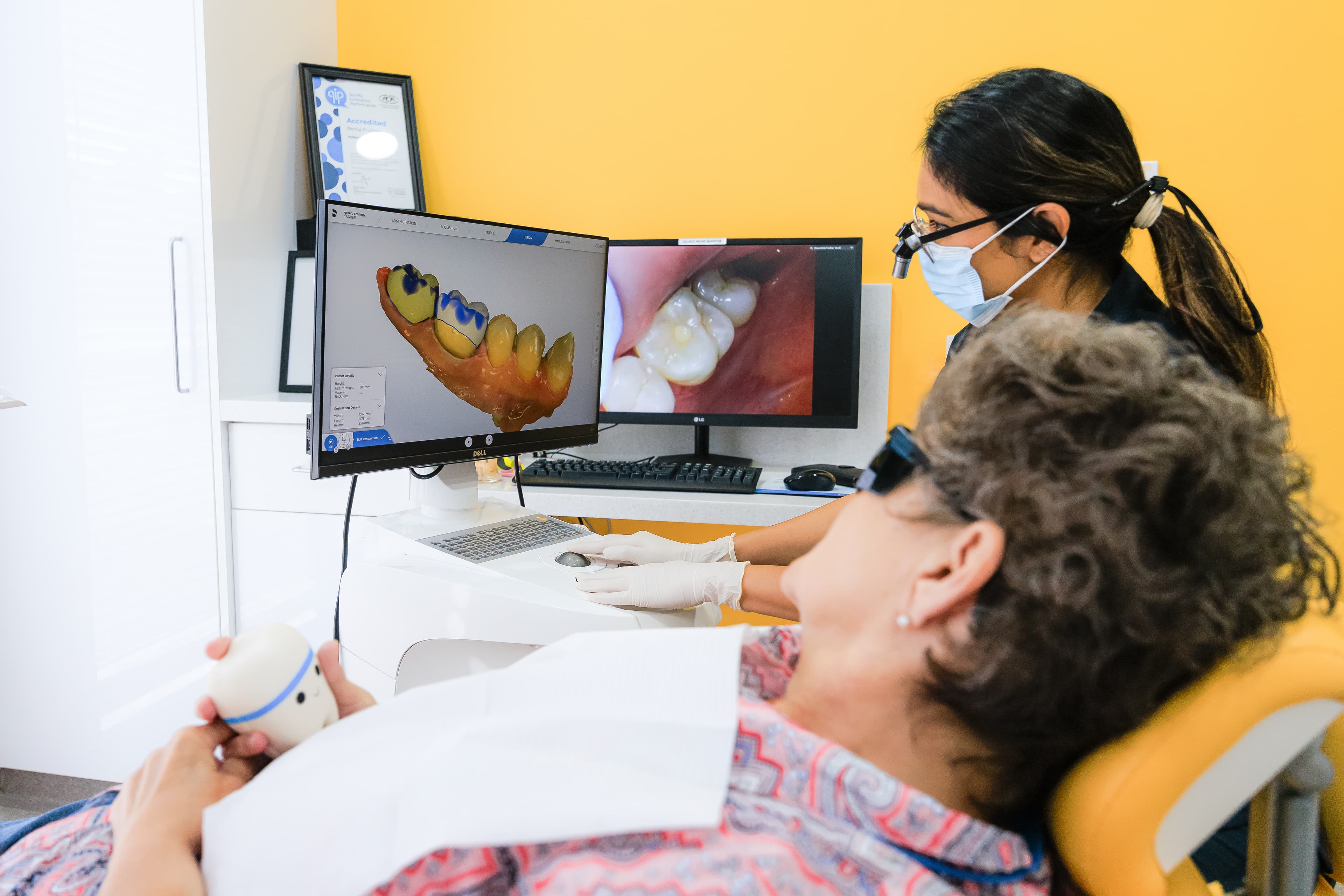 Dentist showing a patient their dental assessment findings at Sienna Smiles