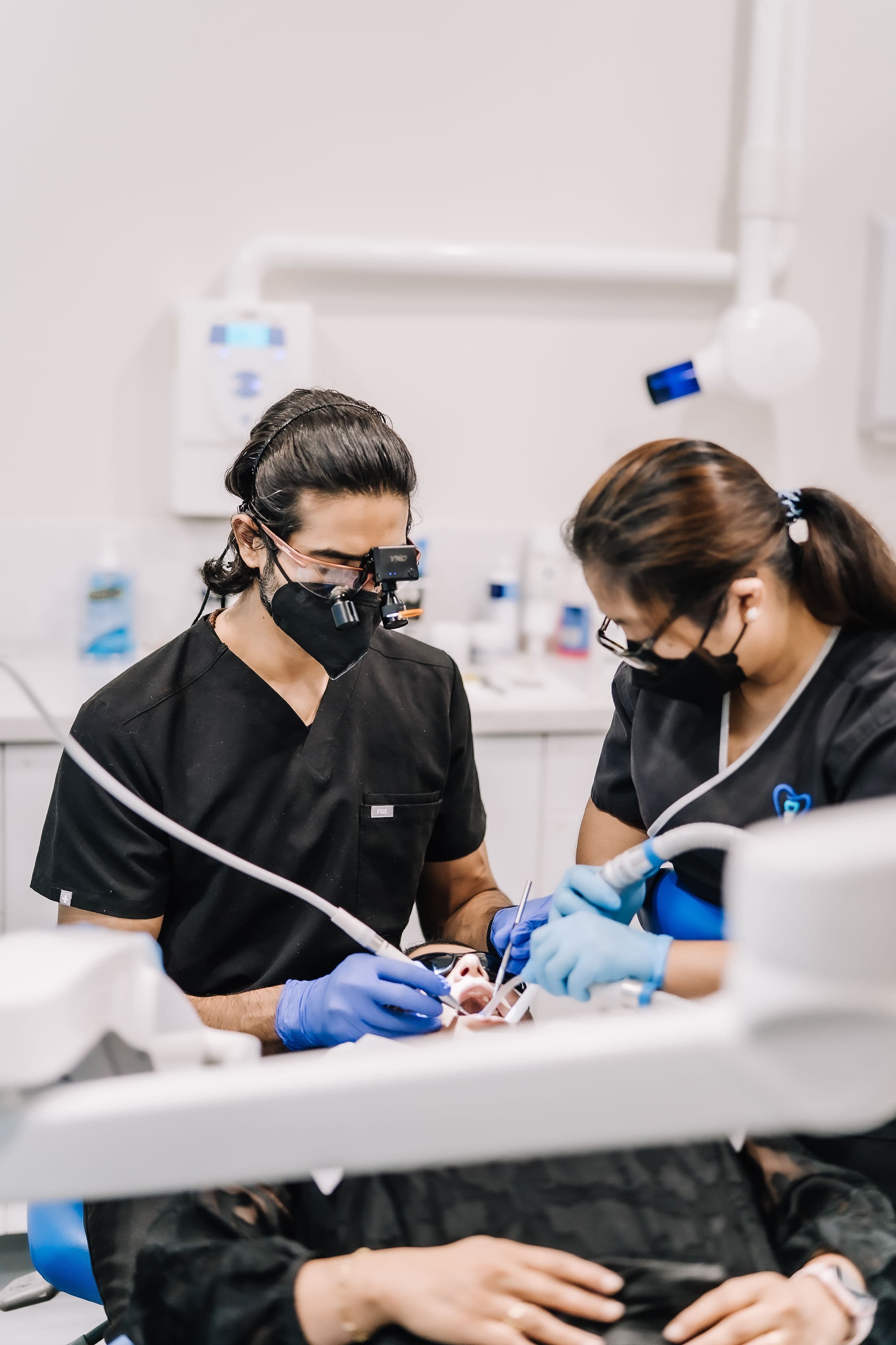 Dentist showing a patient their dental assessment findings at Sienna Smiles