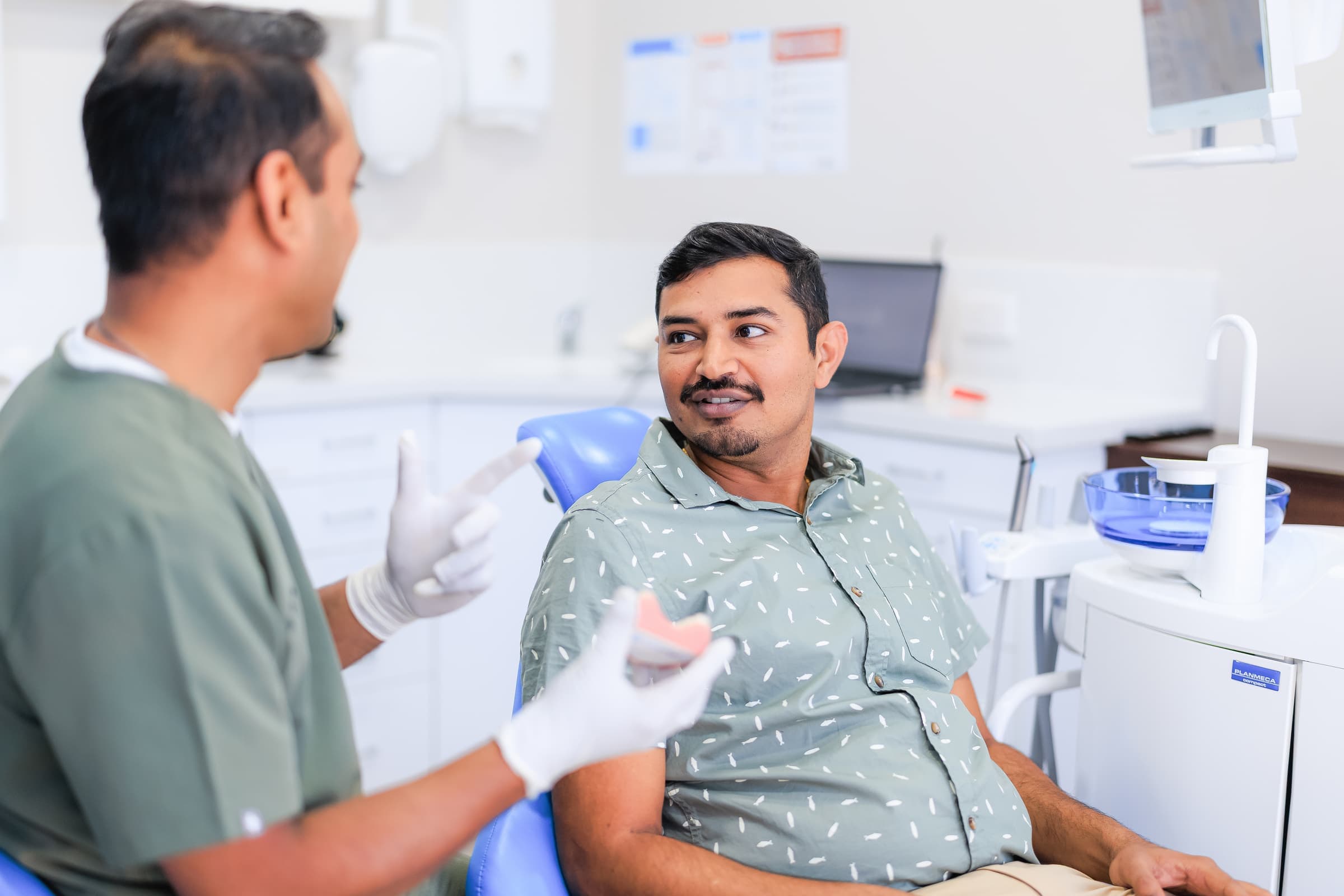 Dentist discussing a smile makeover treatment plan with a patient at Sienna Smiles
